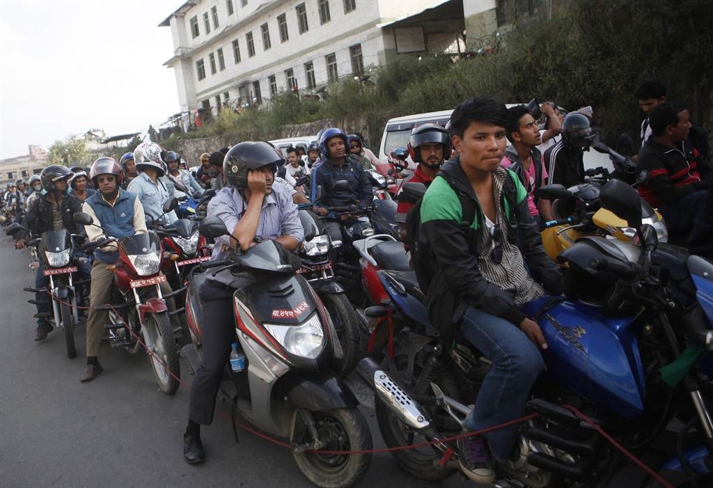 Nepalis carpool on scooters. Image via AM 1380 The Answer